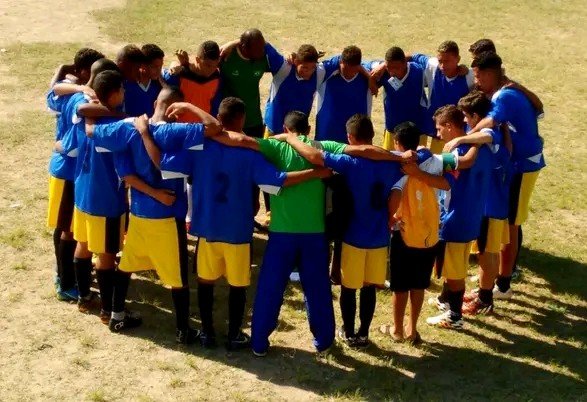 Foto oficial da Escolinha de Futebol do Instituto Pedro S. Leopoldo, com crianças e adolescentes jogando futebol em campo gramado